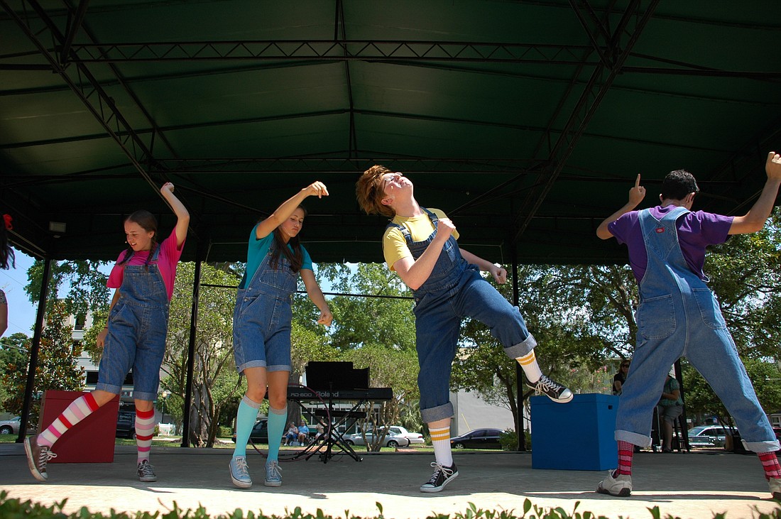 Photo by: Isaac Babcock - Players from the Winter Park Playhouse dance up a storm during their production of "Schoolhouse Rock Jr." on Saturday morning at Central Park's north stage.