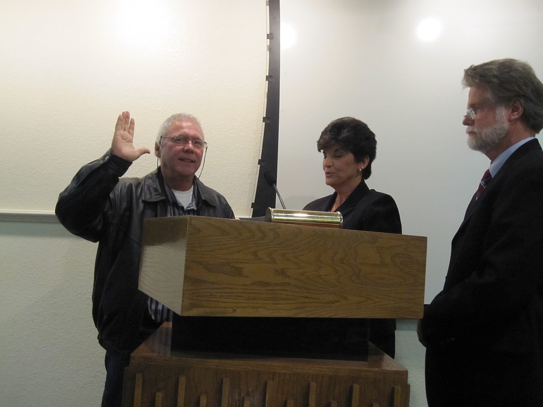 Photo by: Jenny Andreasson - New Maitland City Councilman Robert Breaux takes the oath of office on Monday. He was appointed to Seat 1.