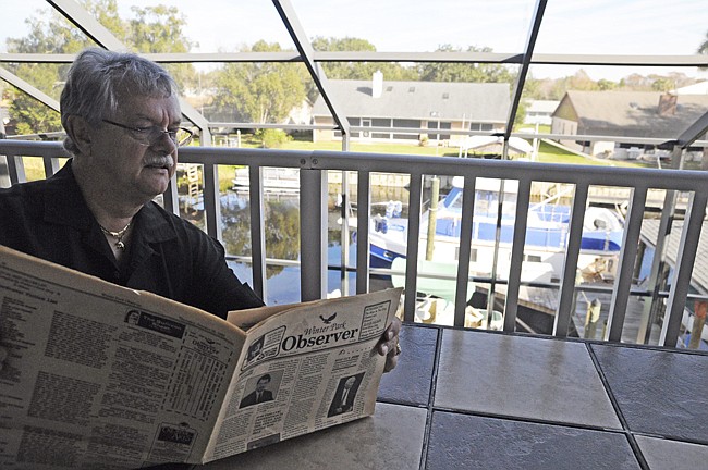 Photo by: Isaac Babcock - Winter Park/Maitland Observer founder Gerhard Munster reads a copy of the paper's first issue, which was published 25 years ago this week. He retired in 2007 after serving as editor and publisher of the award-winning paper fo...