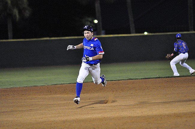 Photo by: Isaac Babcock - Chan Hyeok Song legs out a triple in the opening game of the Florida Collegiate Summer League's series against South Korea.