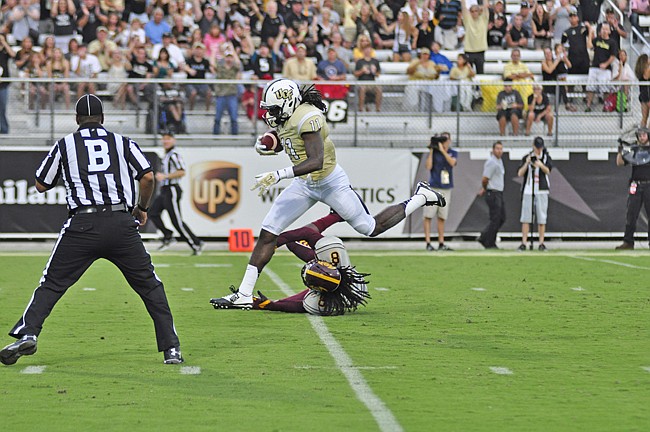 Photo by: Isaac Babcock - Breshad Perriman bowls over a BCU defensive back en route to the Knights win two weeks ago. They've had a long rest to prepare for a rematch against Houston.
