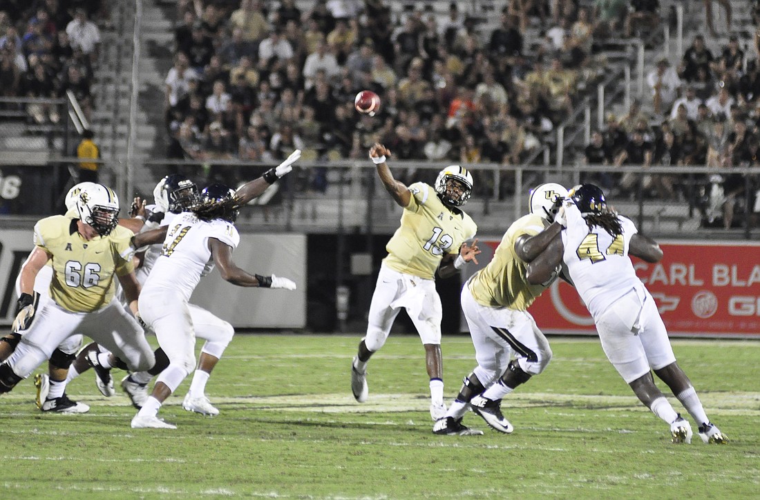 Photo by: Isaac Babcock - UCF quarterback Justin Holman (shown playing FIU Sept. 3) is out reportedly 2-4 weeks after a hand injury during the Knights' Sept. 12 loss to Stanford, which extended into early Sunday morning.
