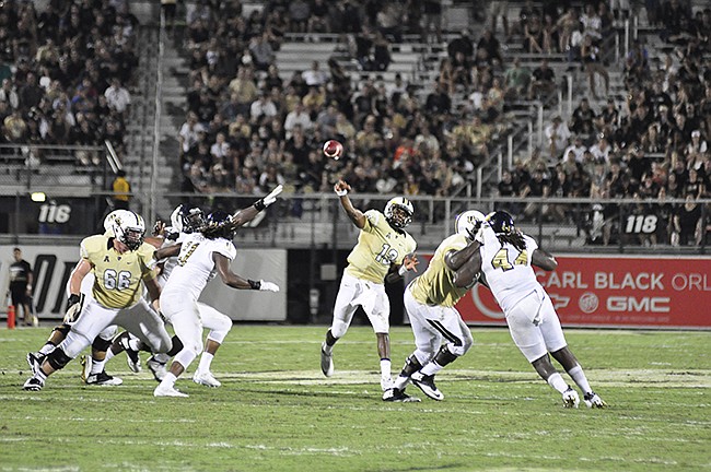 Photo by: Isaac Babcock - UCF quarterback Justin Holman was taken out for an estimated 2-4 weeks with a hand injury early in the Knights' loss to Stanford.