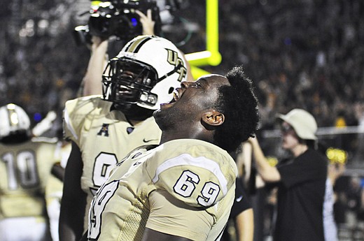 Photo by: Isaac Babcock - UCF defensive lineman Thomas Niles celebrates moments after the UCF Knights stopped the BYU Cougars at the goal line to secure an overtime win in the early morning hours of Oct. 10.