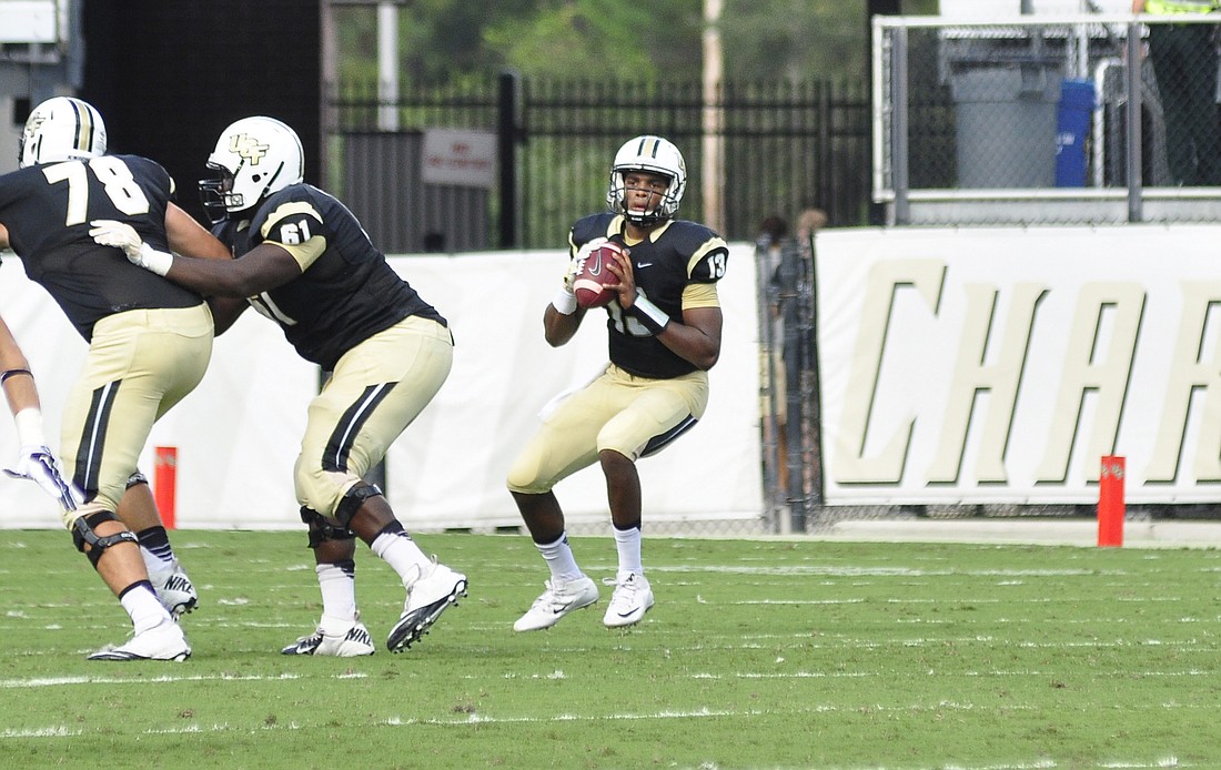 Photo by: Isaac Babcock - UCF quarterback Justin Holman has a long way to go to regain his game one form, after throwing for only 67 yards in the Knights' defeat by Temple. He faces a Houston team that's amassed 555 yards per game in 2015.