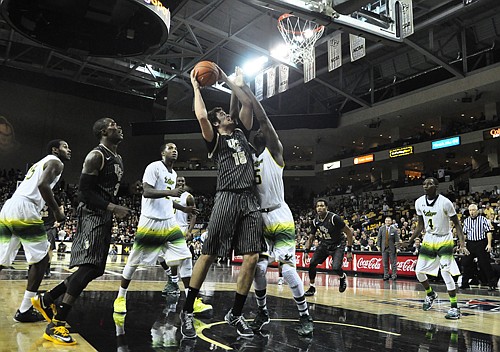 Photo by: Isaac Babcock - UCF forward Dylan Karell fights for the basket in the final minutes of the Knights' narrow loss to USF on Feb. 5.