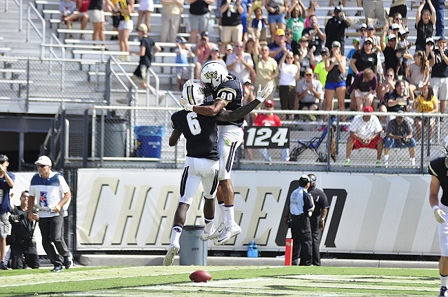 Photo by: Isaac Babcock - The Knights had few reasons to cheer in 2015, but one of them, receiver Tre'Quan Smith, above right, caught 724 yards of passes, earning an American Athletic Conference Rookie of the Year award.