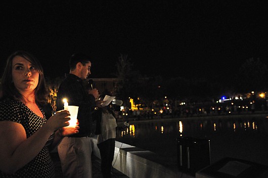 Photo by: Isaac Babcock - Melissa Catalanotto holds a candle during the memorial vigil for slain journalist and UCF alumnus Steven Sotloff at UCF's reflecting pond Wednesday.