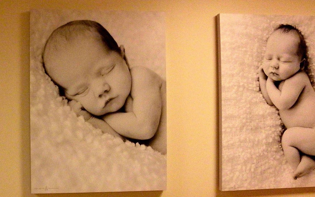Photo by: Brittni Larson - Photography of newborn babies line the walls of Winter Park Memorial Hospital's Dr. P. Phillips Baby Place.