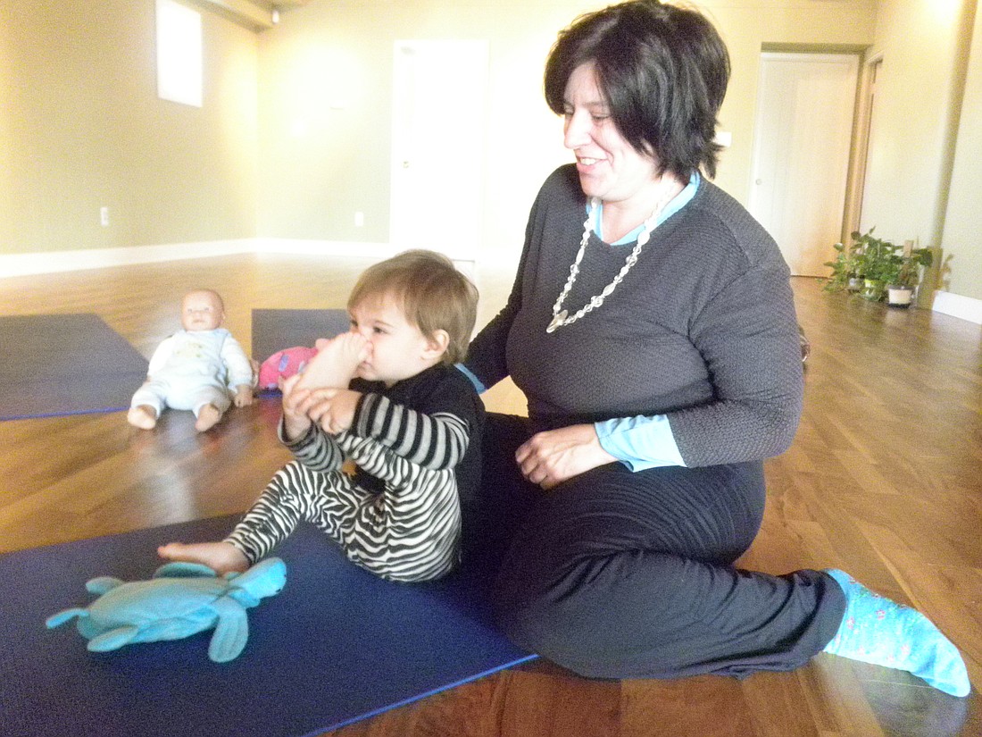 Photo by: Brittni Larson - Shari Aronin and her 18-month-old daughter, Lilah Aronin, practice yoga at Mindful Body of Maitland on Dec. 9.