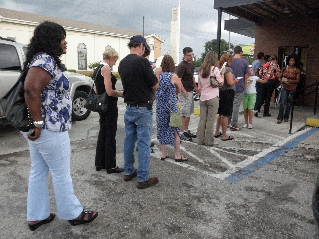 Photo by: Brittni Johnson - Patrons at Winter Park barbeque eatery wait in line on a drizzling Saturday afternoon. The lines often extend out to the road.