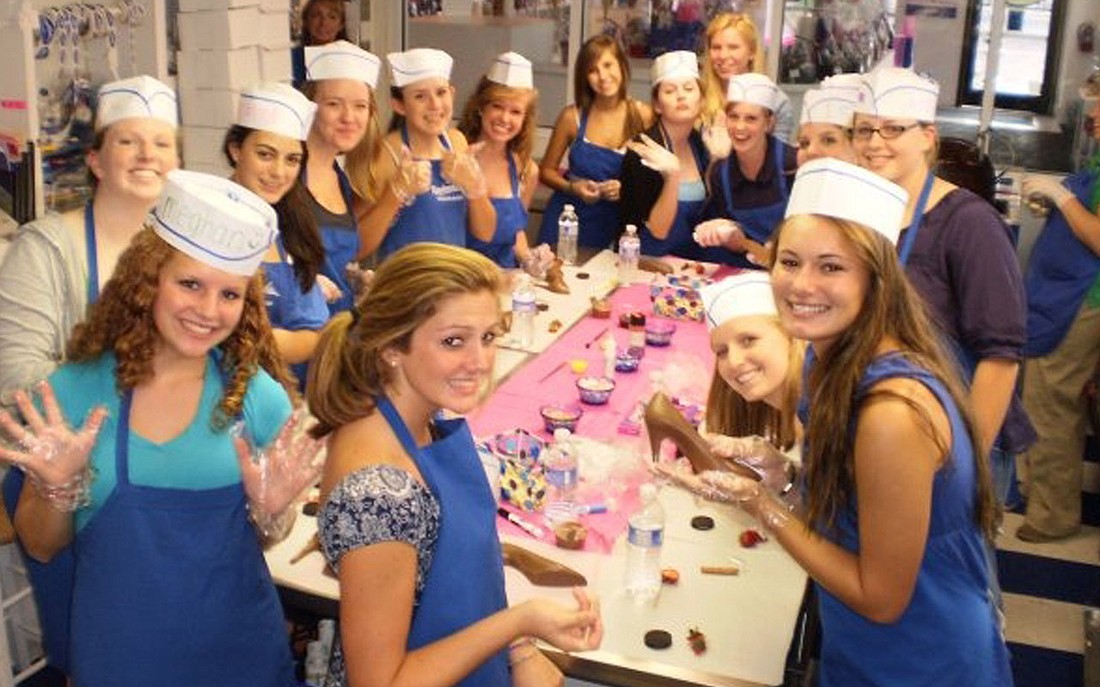 Students at last year's Peterbrooke Chocolatier Chocolate Camp decorate chocolate shoes.