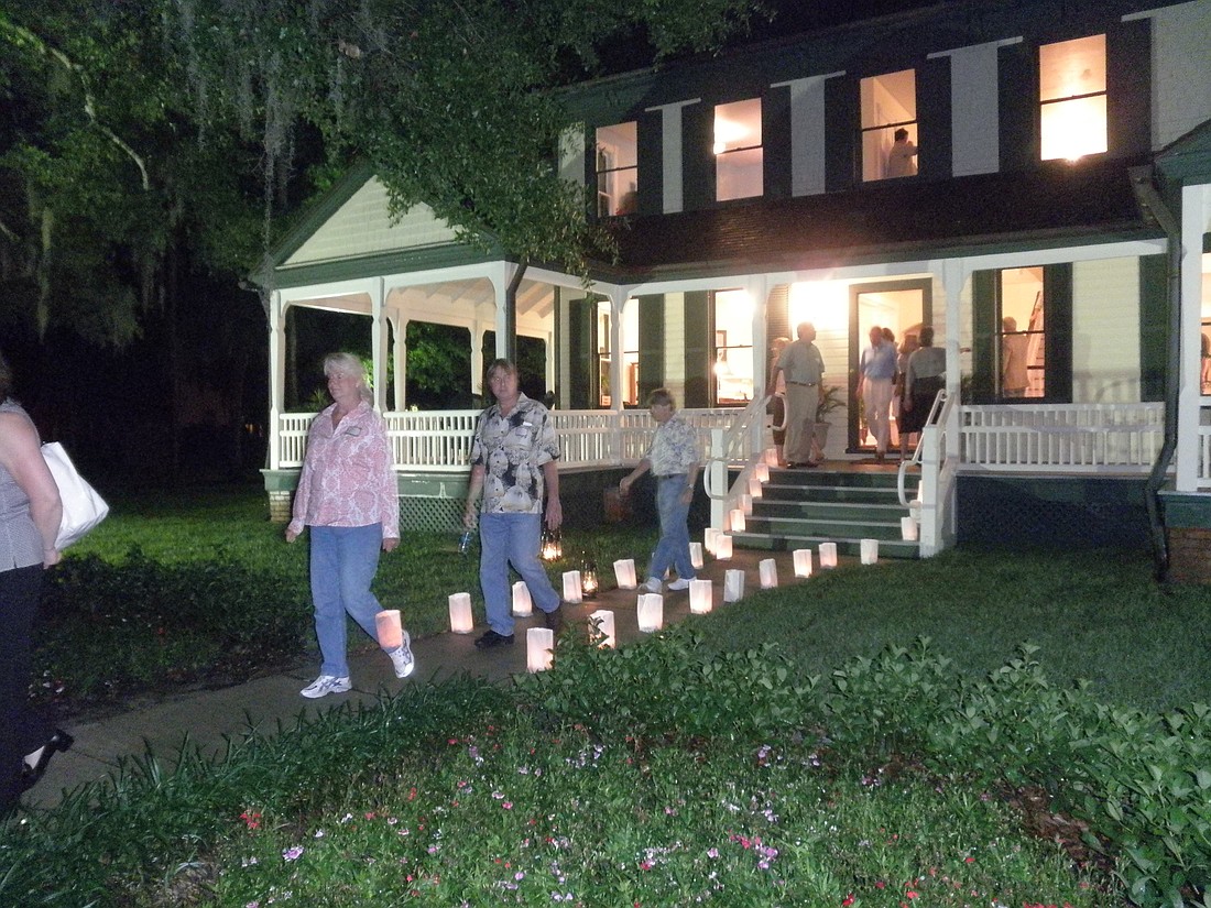 Photo by: Frank Roark - Folks on a candlelit tour of historic Winter Park buildings on Thursday enjoyed the speeches of James Gamble Rogers and Hamilton Holt impersonators.