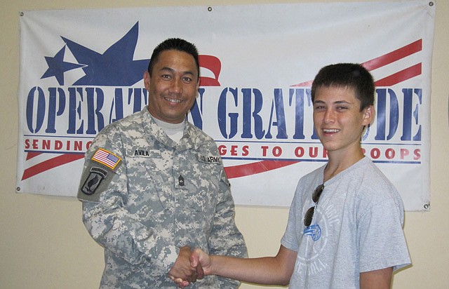 Andrew Weinstock meets with a member of the military.  Weinstock has been collecting candy for care packages to send to troops with the organization, Operation Gratitude.