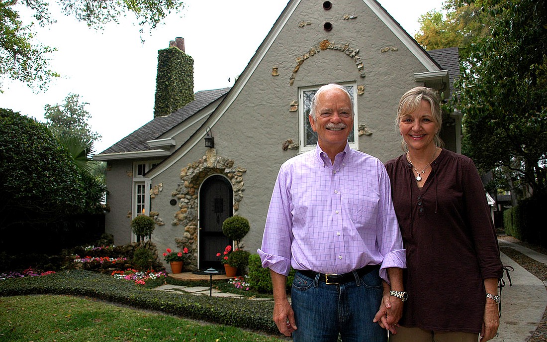 Photo by: Isaac Babcock - Dennis and Kate Tracy stand in front of their home on Palmer Avenue, the "Dawn Treader Cottage."
