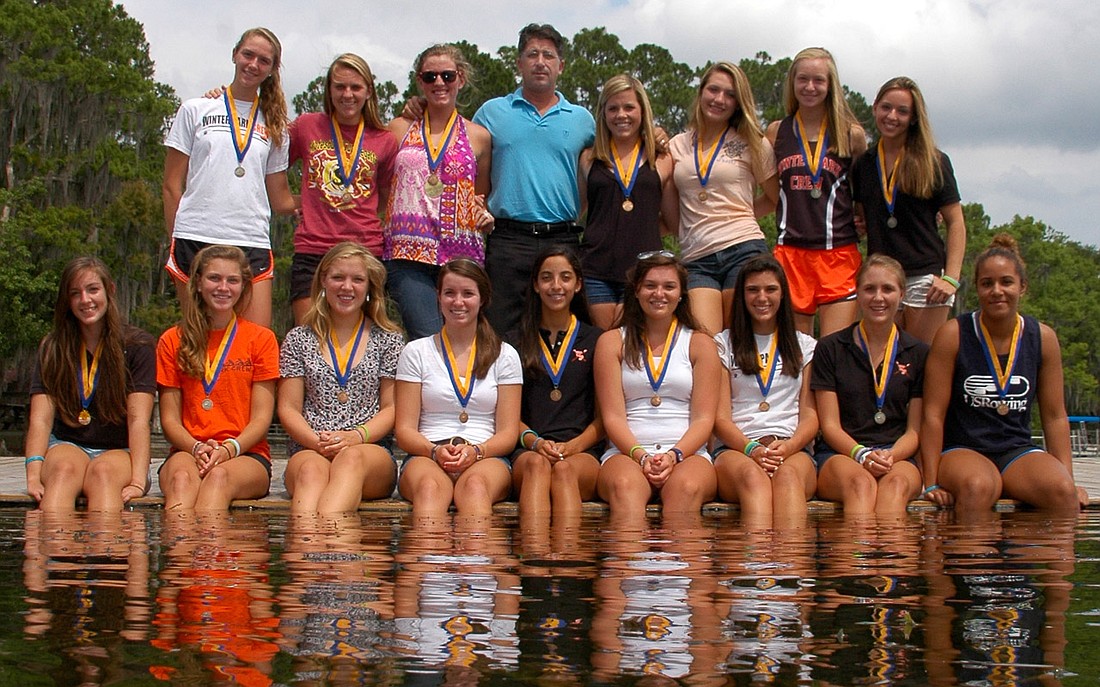 Photo by: Isaac Babcock - The 2010-2011 Winter Park High School girls' crew team, pictured with Coach Mike Vertullo, made history at the Stotesbury Cup.