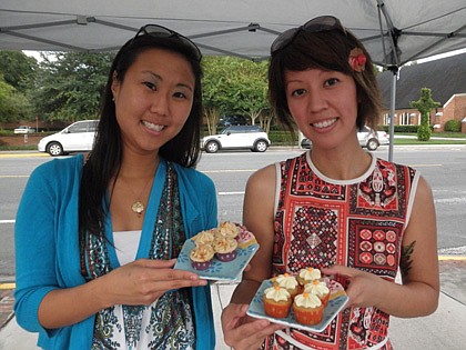 Photo by: Brittni Larson - Emily Bowers and Erica Abalos-Hernandez pose with their Sweet Treat setup at the College Park Farmer's Market.