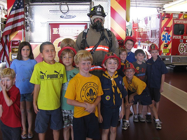 Fully outfitted Winter Park fireman John Bonnell played host at a firehouse tour for First United Methodists Cub Scout Troop 678 recently.