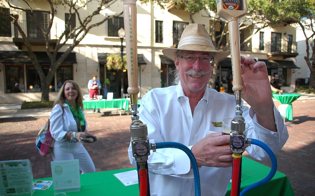 Photo by: Isaac Babcock - Orlando Brewing Company President John Cheek pours a pint at The Hannibal Square Wine Tasting & St. Patrick's Day Street Party on March 17 on New England Avenue.