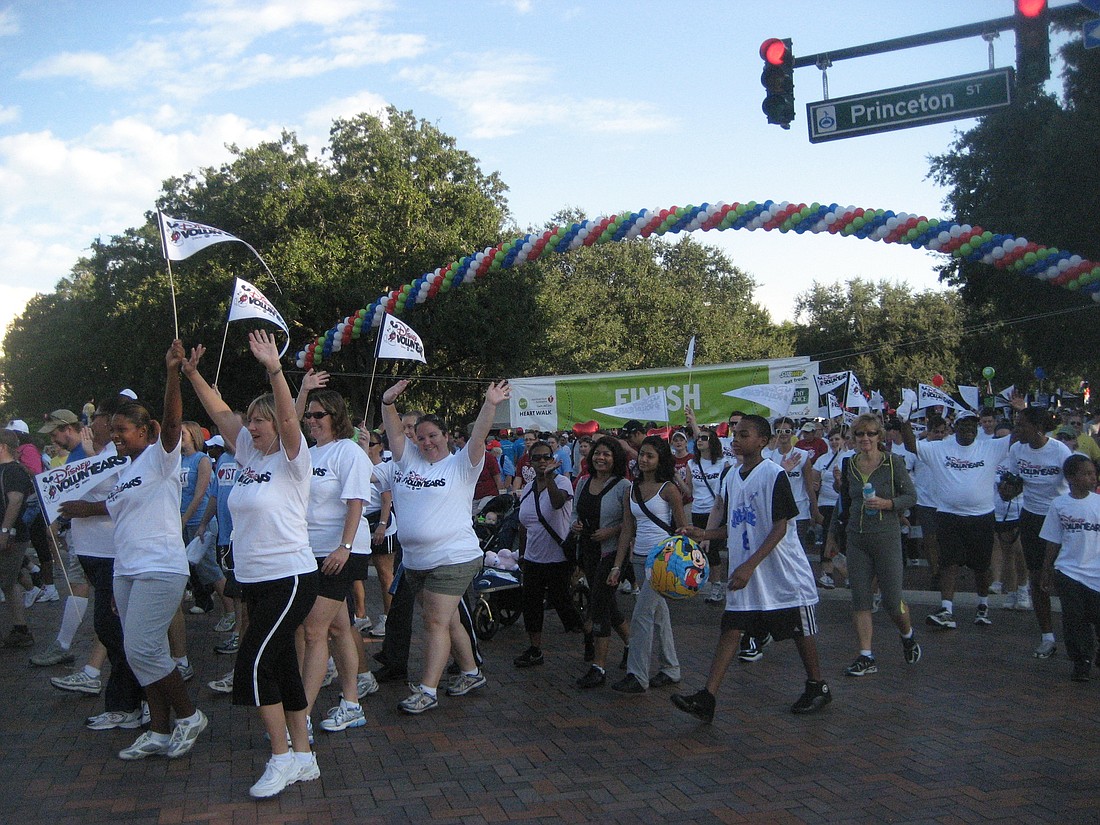 Photo courtesy of American Heart Association - Walkers cross the finish line at the 2009 American Heart Association Start! Heart Walk on Princeton Street in Orlando. Walks are held all over the country to raise money for vital research.