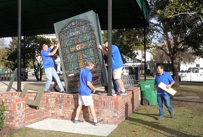 Photo by: Clyde Moore - Teams of workers come together to set up the Tiffany windows in preparation of the Morse Museum's annual Christmas in the Park celebration.