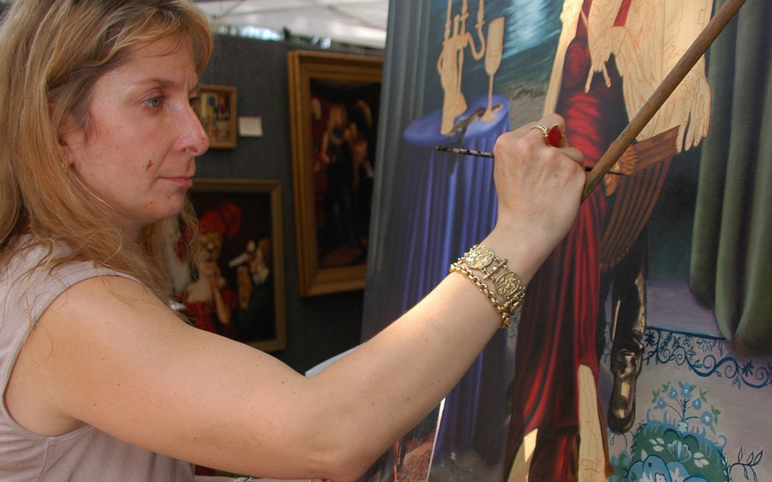 Photo by: Isaac Babcock - Lisa Russo works on an oil painting on Saturday, April 16, at the Maitland Spring Festival of the Arts.
