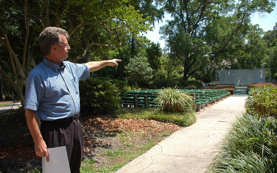 Photo by: Isaac Babcock - Mead Botanical Garden Inc. director Jeff Blydenburgh points to a stage which could be supplemented by an outdoor concert pavilion near the park's waterfront.