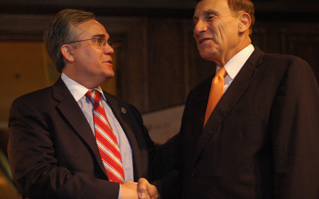 Photo by: Isaac Babcock - Congressman John Mica, right, shakes hands with Winter Park Mayor Ken Bradley at a SunRail event last year. Bradley supports the rail line.