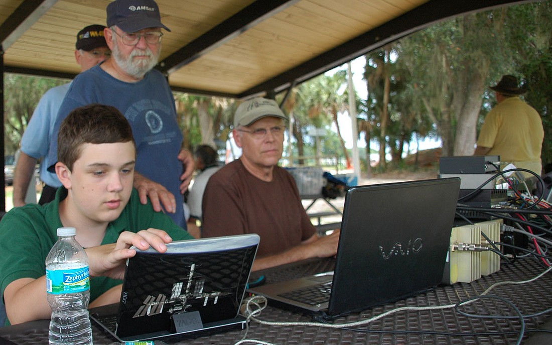 Photo by: Isaac Babcock - Members of the Lake Monroe Amateur Radio Society track a satellite at the annual Field Day event, a 24-hour marathon that sees teams compete.