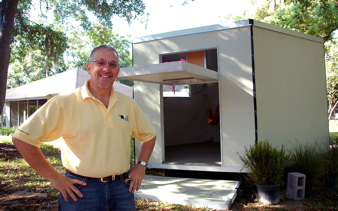 Photo by: Isaac Babcock - World Housing Solution President Ron Ben-Zeev shows off one of his disaster shelters at the Church of the Good Shepard in Maitland on Saturday.