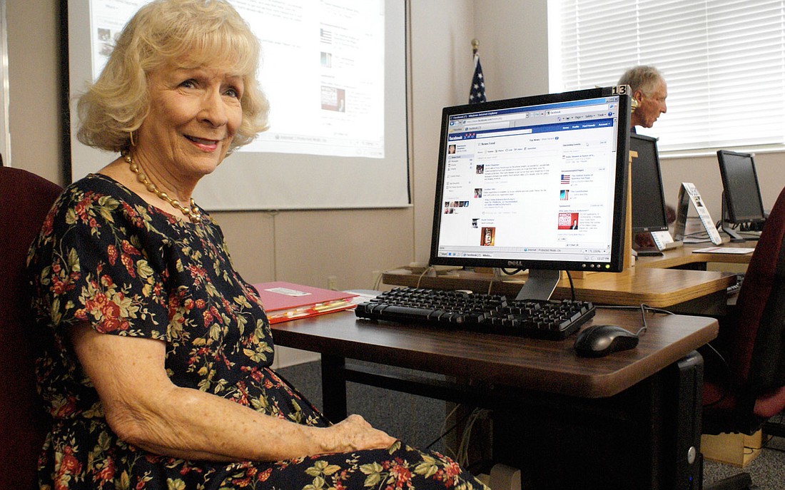 Photo by: Amy Simpson - Rosie Chapman checks her Facebook before teaching a Seniors Now class.