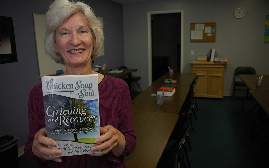 Photo by: Isaac Babcock - Bettie Wailes tutors college prep classes, but has turned writing into a source of fame. Here she shows off  "Grieving and Recovery," in which her story "The Secret Shopper" appears. The author is also an avid runner, competi...