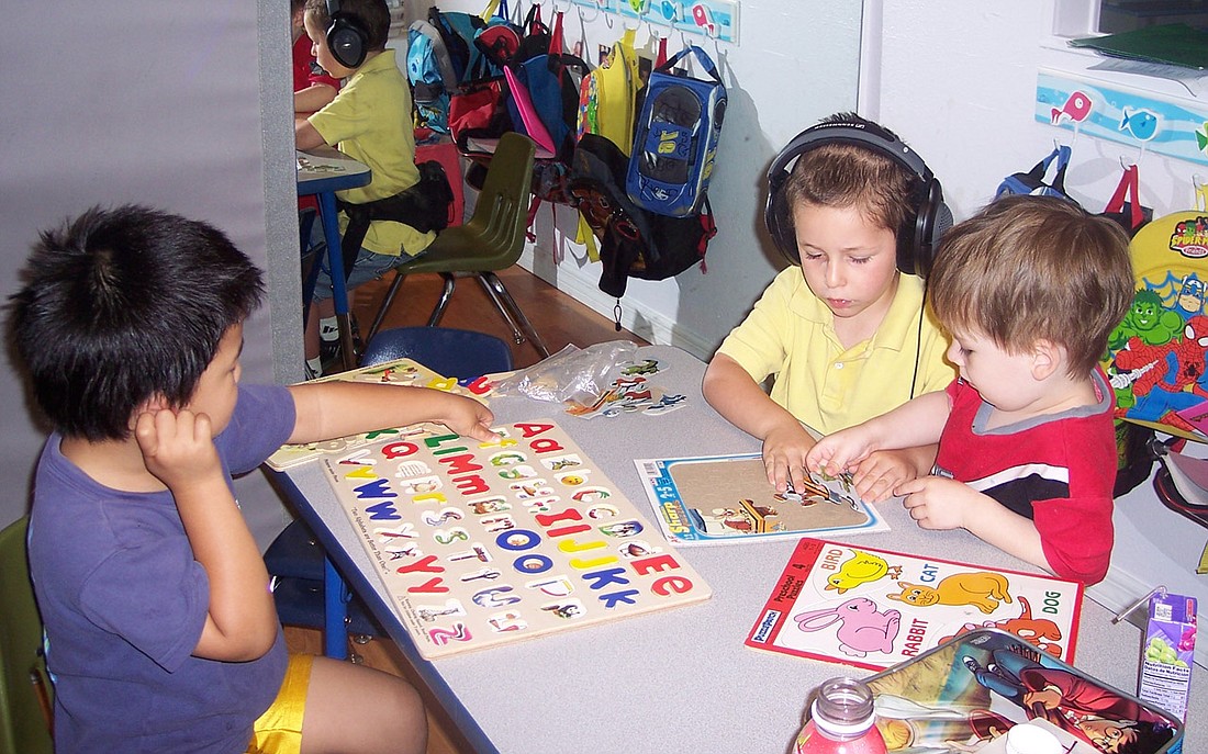 Photo courtesy of A.LL Therapy Connection - From left, Jae, 4, J.D., 4, and Trent, 3, work on puzzles and listen to music at A.LL Therapy Connection in Maitland.