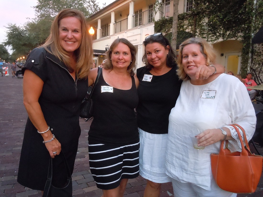 Photo by: Clyde Moore - Joanie Stoddard (left), Winter Park High School alumna, and Lisa Lyle (right) enjoy the Winter Park High School Get Together in Hannibal Square with sisters and alumnae Laura and Kim Burst.