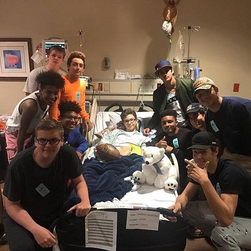 Members of the freshman football team lifted Brandon Paulikas&#39;      spirits during a recent hospital visit.