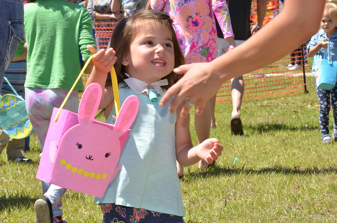 Three-year-old Audrey Burkhalter shows off her collection of eggs at Oaklandâ€™s Celebration Among the Oaks.