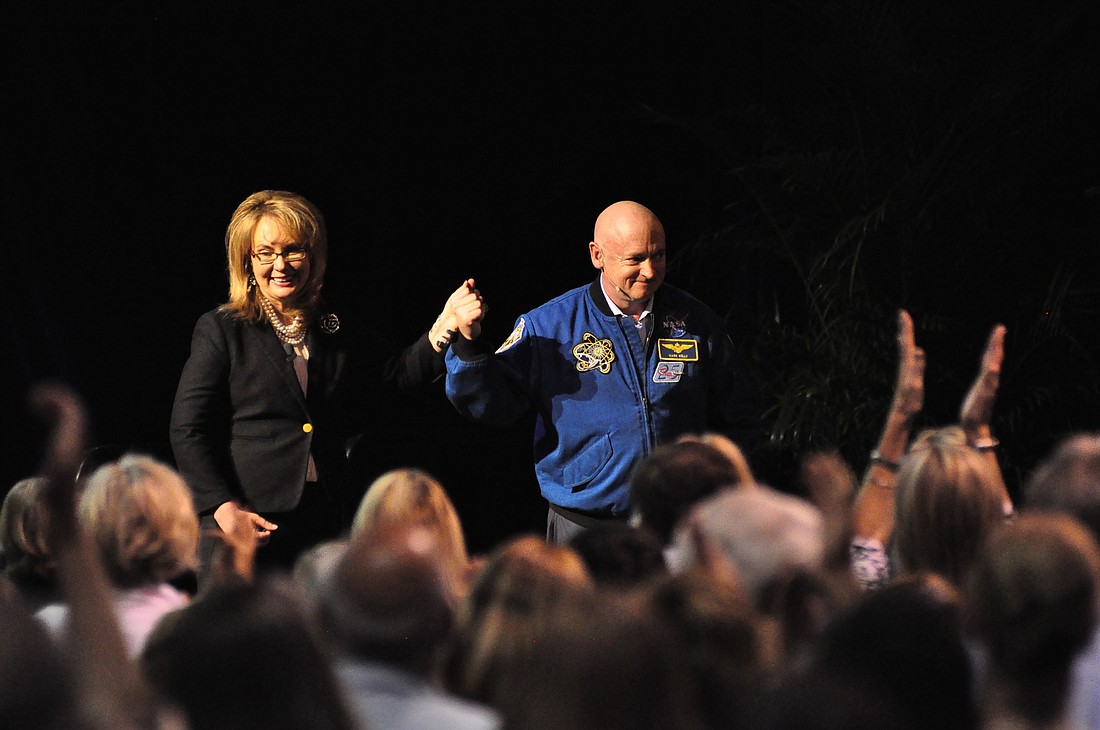Former Congresswoman Gabrielle Giffords and former NASA Astronaut Mark Kelly cross the stage at Rollins College