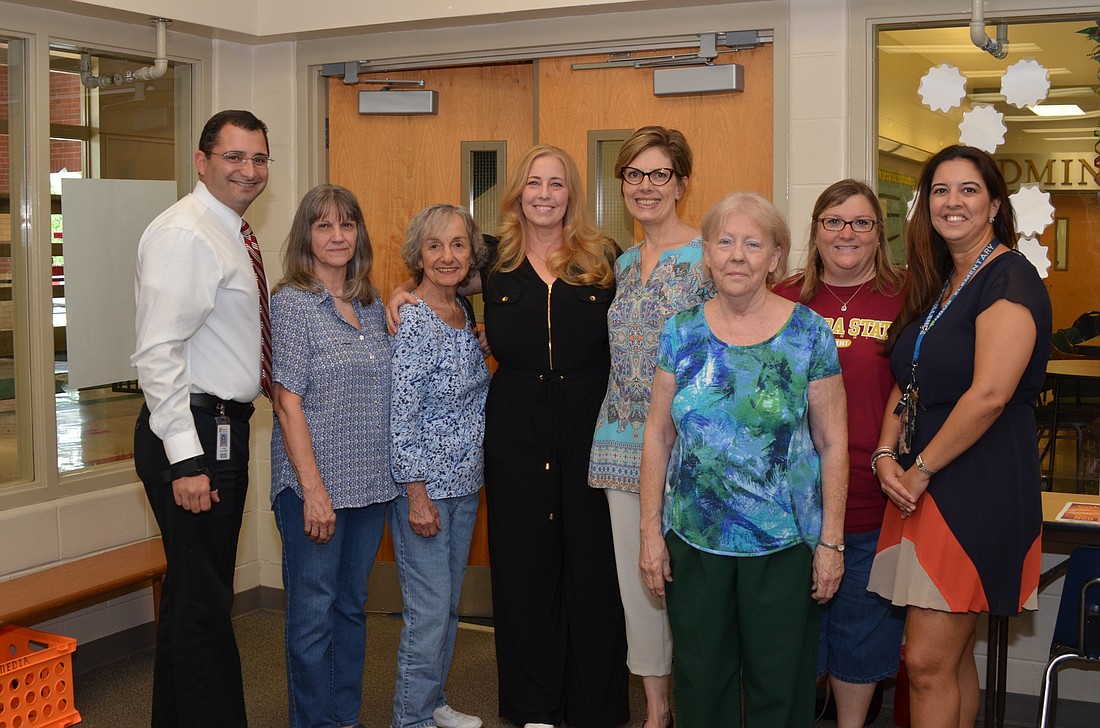 Kimmie Laird, 4th from left, visits with former co-workers who returned to Dillard Street for her retirement party: Mark Shanoff, Angie Laird, Rosemary Gates, Cindy Gooseman, Nancy Smith, Lisa Recca Sowers and Liana Hulcher.