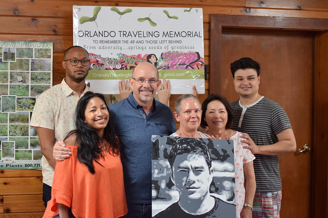 The Wright family displays Jerryâ€™s completed portrait. From left: Javon Bethel, Aida Wright, Fred Wright, Maria Wright, Judy Swor and Joseph Wright.
