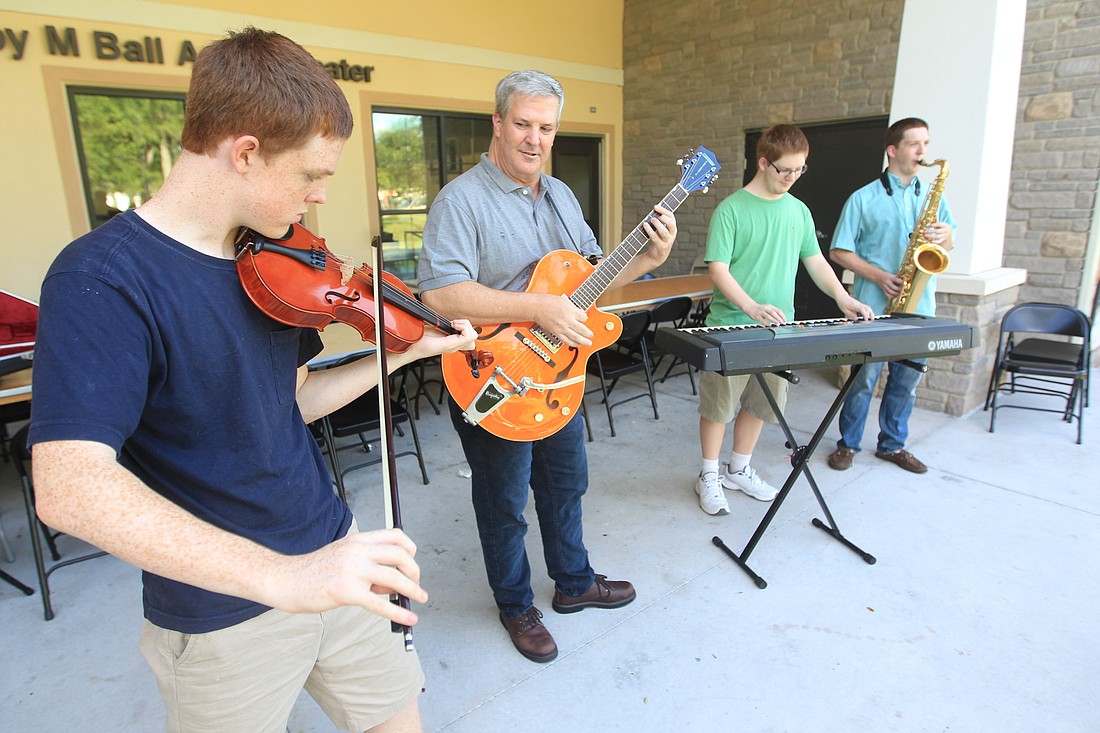 Griffin, Larry, Nolan and Gregory Seel jam out together during some practice time at the amphitheater at Winter Parkâ€™s Community Center