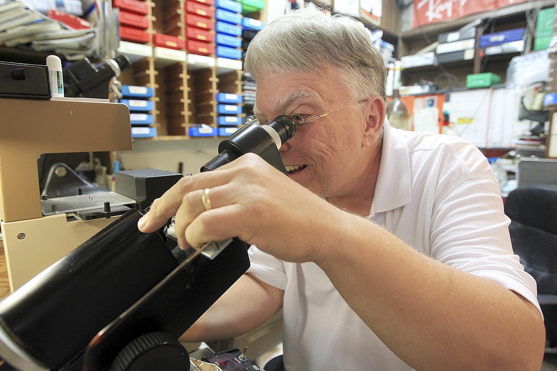 Hal Card works on a pair of glasses in the workshop at Card&#39;s Opticians.