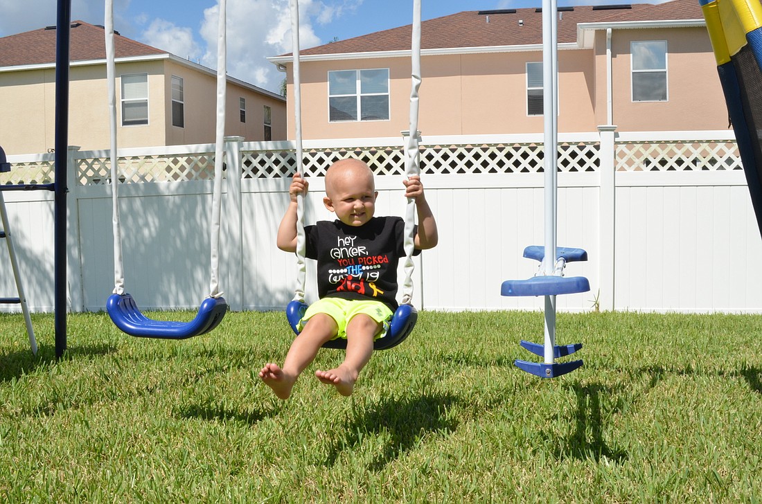 Carter McPherson, 3, enjoys swinging in his backyard.