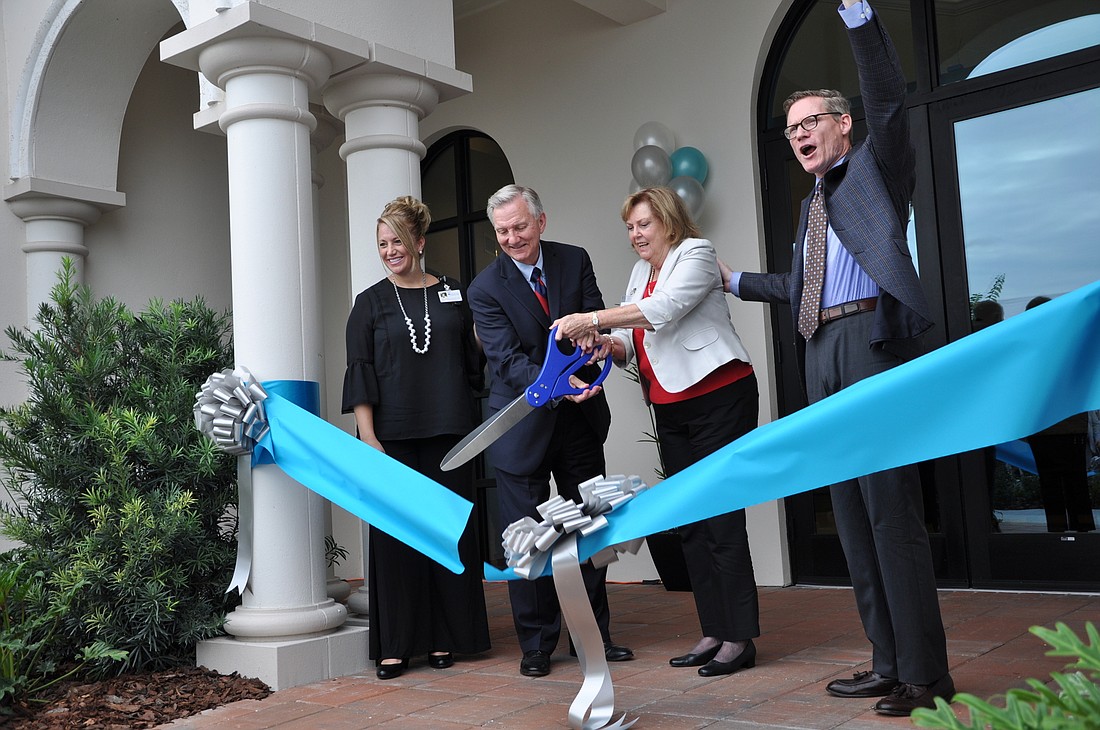 Assistant Executive Director Heather Kessler, Chief Executive Officer Roger Stevens, resident Patricia Lancaster and Executive Director Mike Haye cut the ribbon on the new Westminster location.