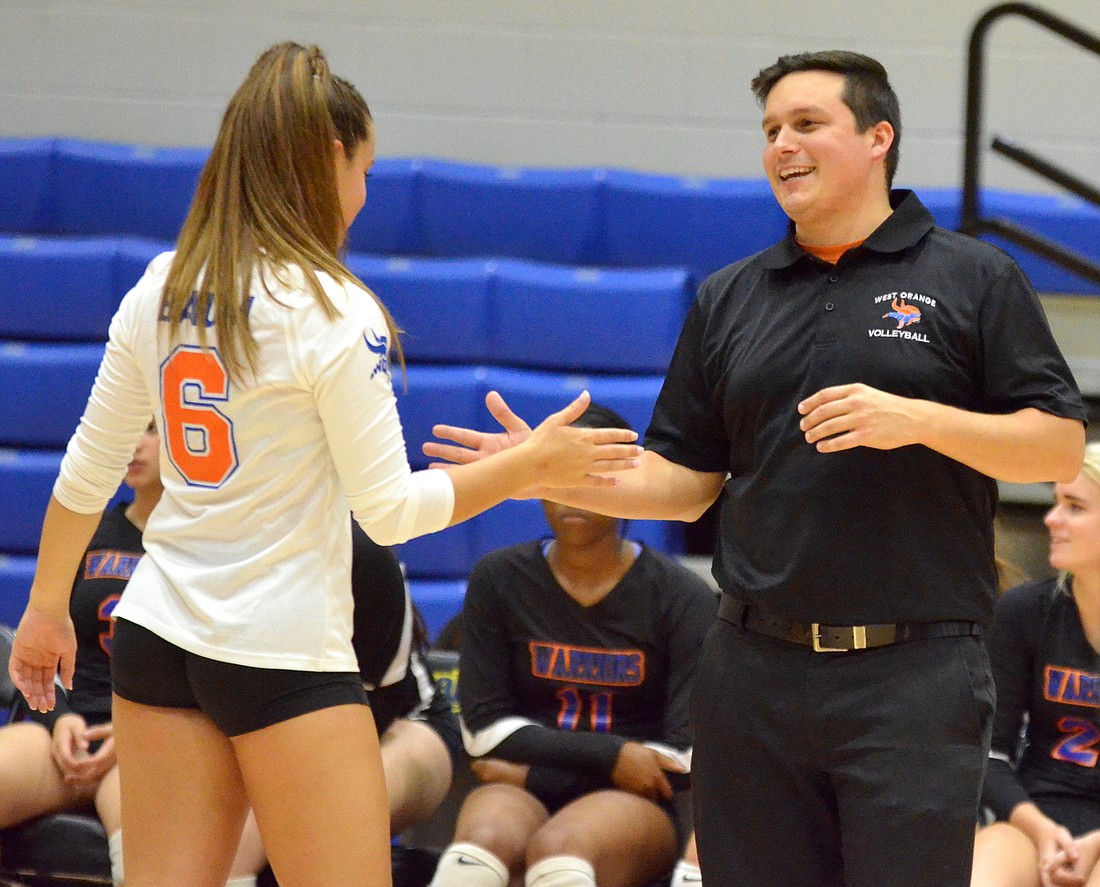 Torey Baum, a Southern California commit, high-fives head coach Ross Usie during a win.