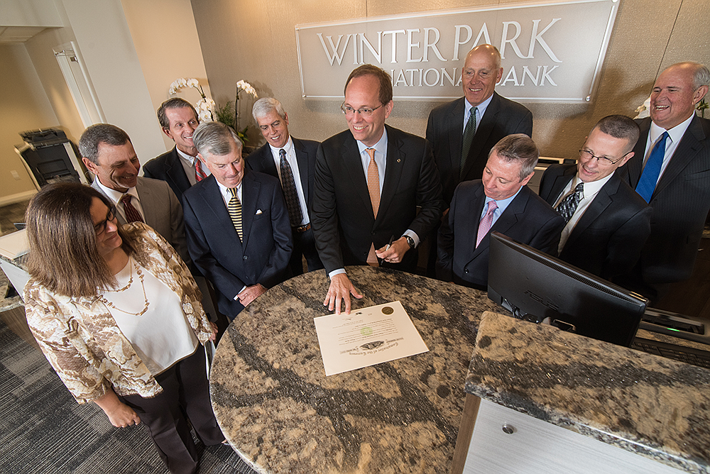 Acting Comptroller of the Currency Keith Noreika (center) signed the first full-service national bank charter since the financial crisis, issued to Winter Park National Bank in Winter Park.