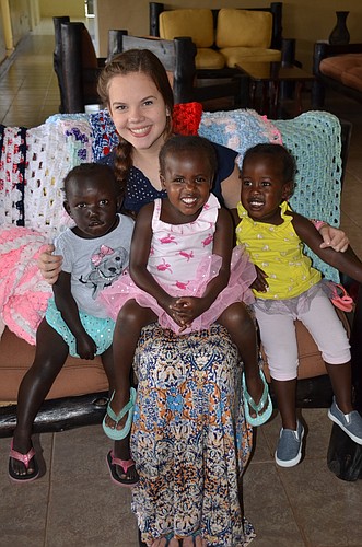 Mackenzie Beach surrounds herself with children from a Kenyan orphanage.
