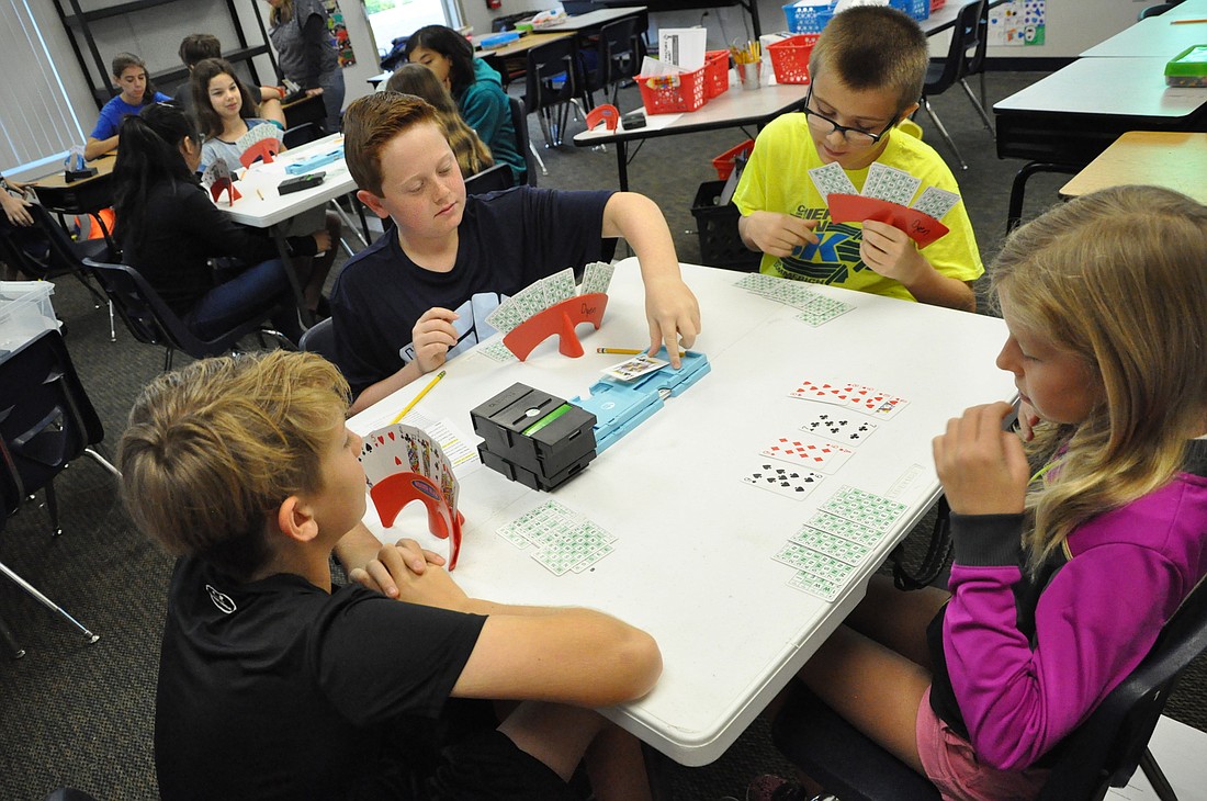Eston Tanner, 11; Ethan Breth, 10; Zachary Rediske, 10; and Meriwether Ruby, 11, have a blast playing bridge every Friday morning at Dommerich Elementary.