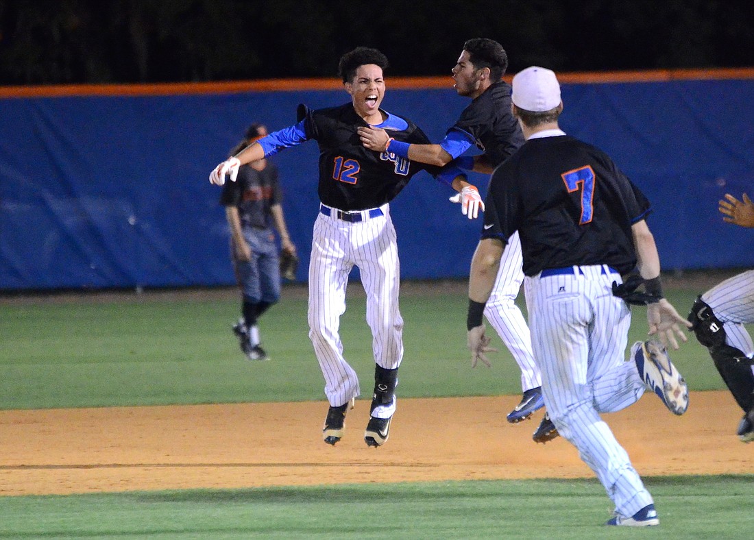 Teammates run out to congratulate Anthony Garcia after his game-winning single.