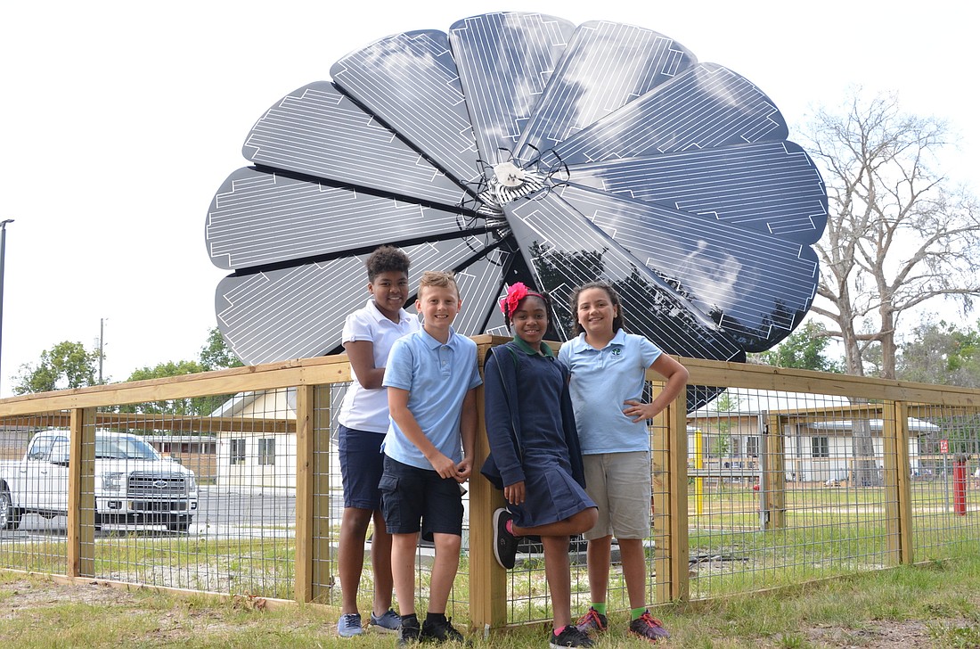 Olivia Rodgers, left, Riley Walker, Yaadele Minnis and Sophia Amorim-Hidalgo are among the students at Innovation Montessori Ocoee who have been eagerly watching the construction of the SmartFlower Solar energy system.