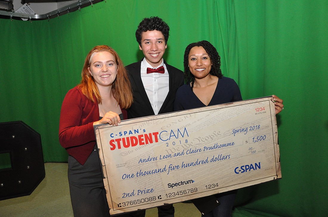 Claire Prudhomme and Andres Leon posed for a photo with their check alongside digital video production teacher Michele Gerber.